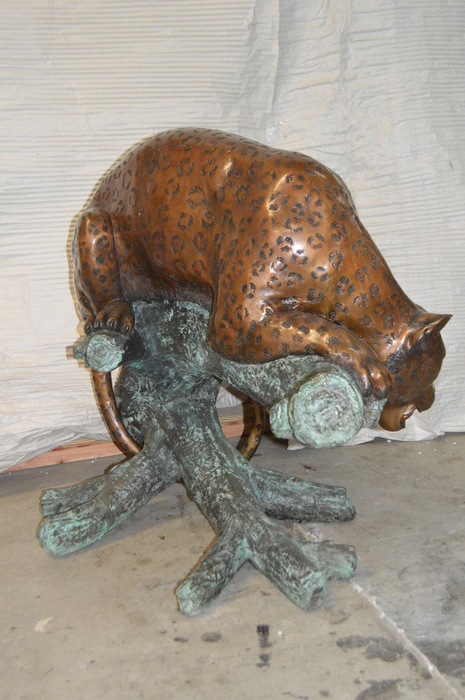 Leopard on a Tree Trunk Bronze Statue -  Size: 38"L x 34"W x 36"H.