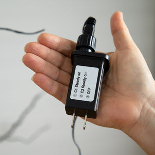 Power adapter shown on white background (close-up accessory).