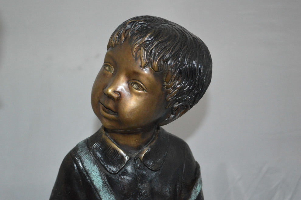Boy and Girl on a tree log reading Bronze Statue -  Size: 37"L x 14"W x 27"H.