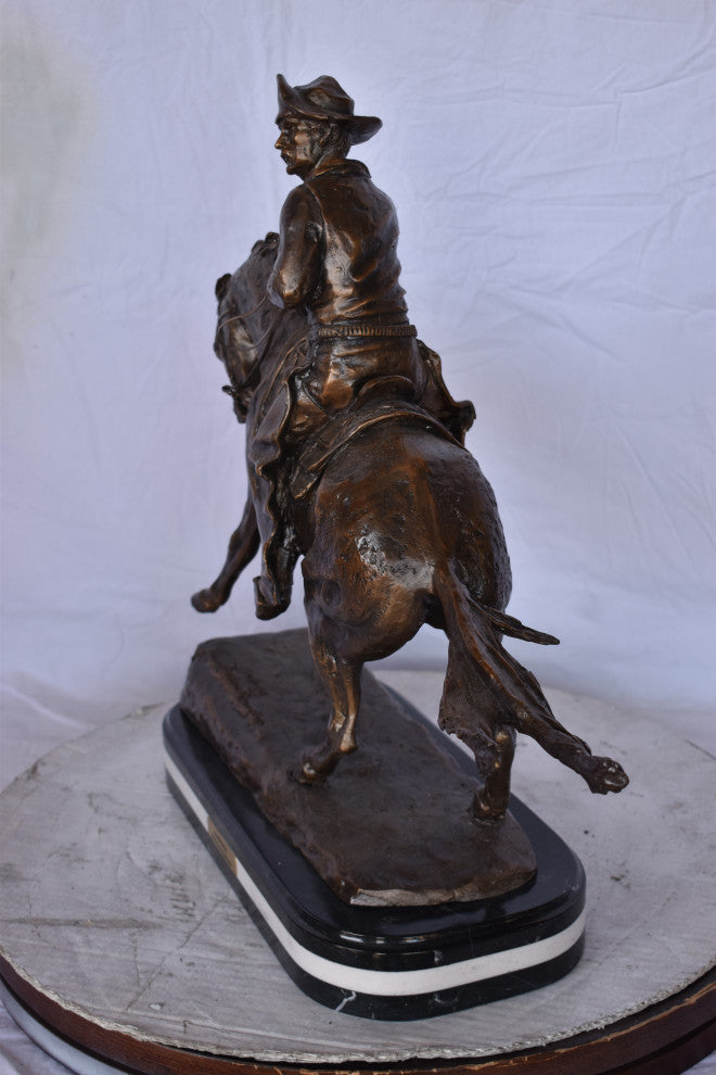 Remington Cowboy Replica Bronze Statue on Triple Marble Size: 8"x 26"x 23"H.