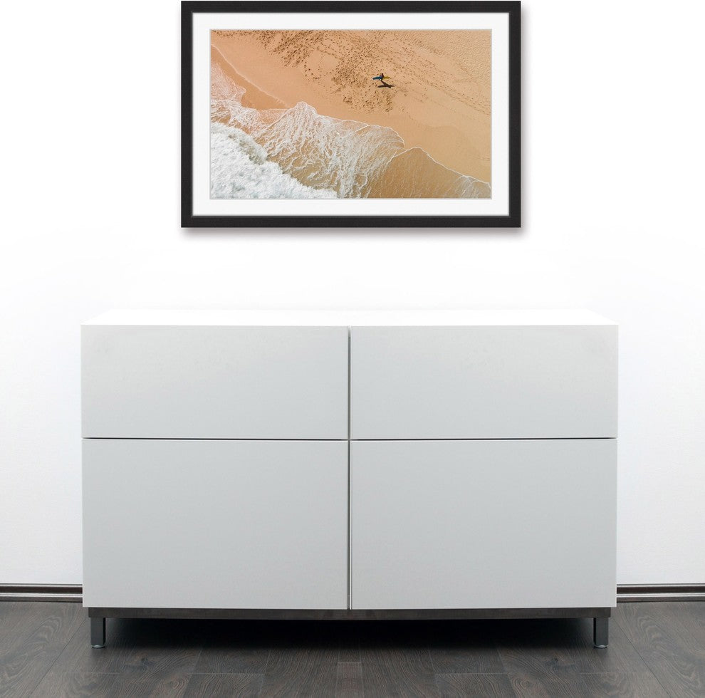"Lapping The Sand" Framed Print by Karolis Janulis