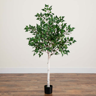 Full tree shown in a real room environment with floor and wall; entire product visible.