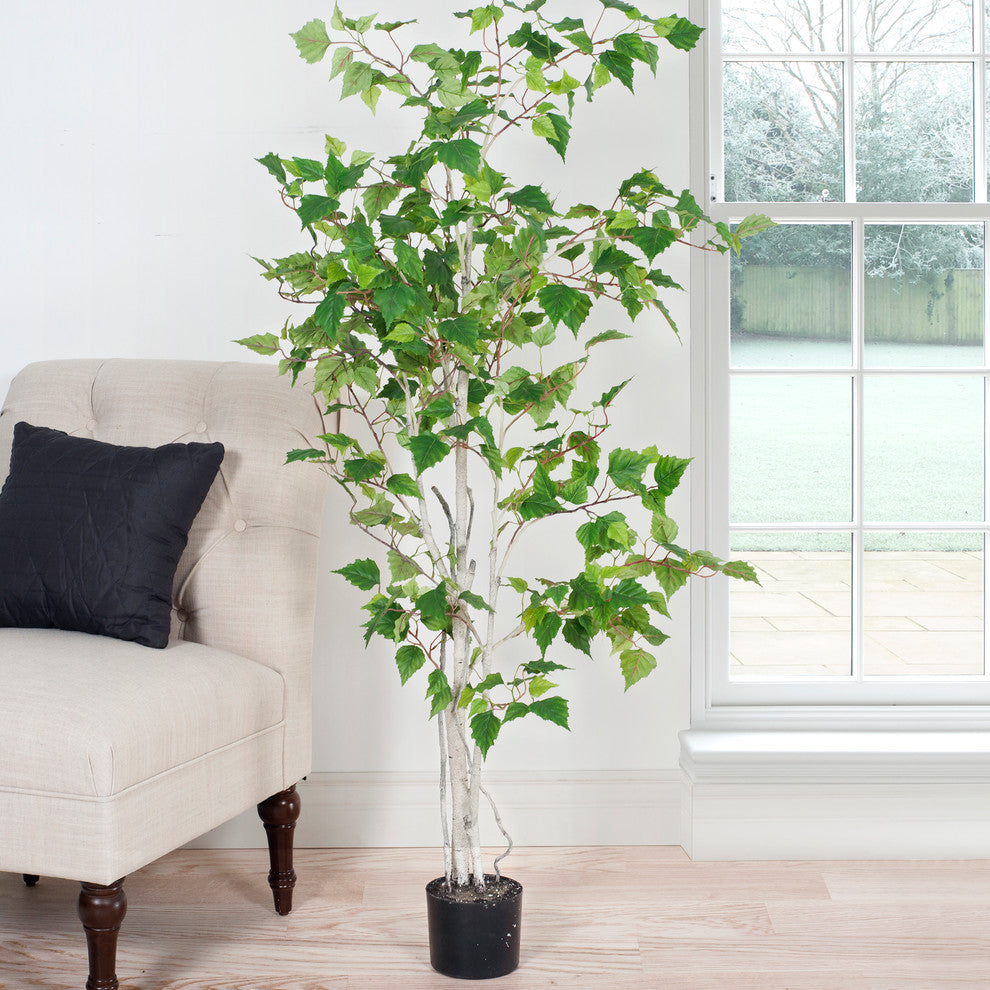 Lifestyle image showing the tree in a room for real-use context.